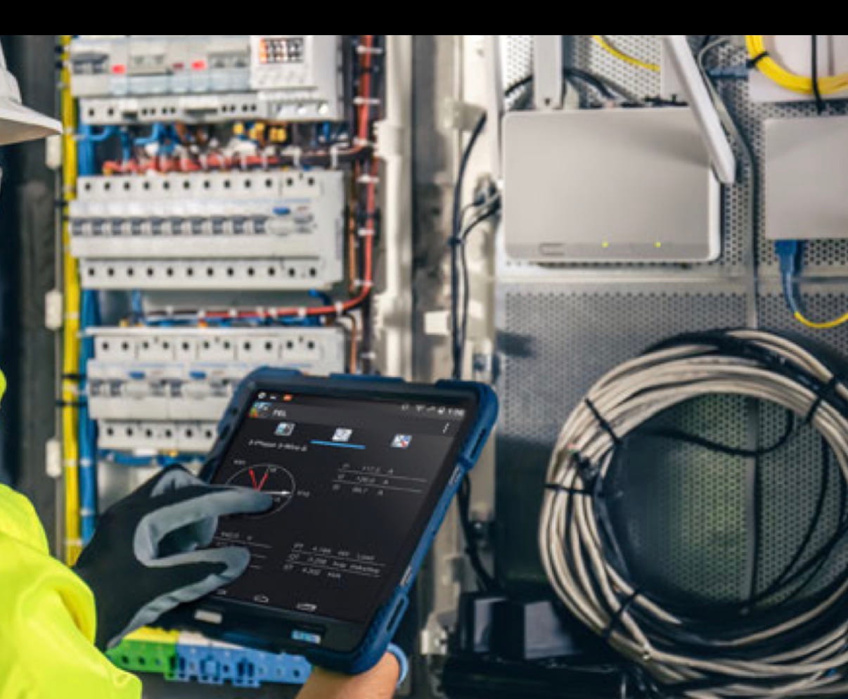 Technicians working near large electrical cabinets
